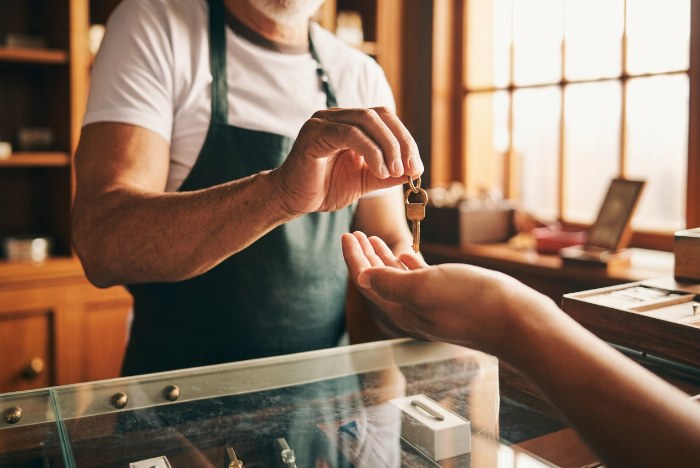 A senior jeweller hands the store keys to a successor across the counter