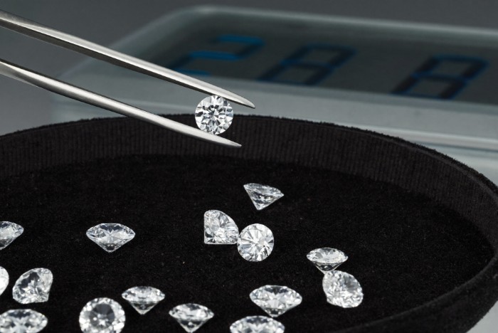 Lab-Grown Diamond Prices in Canada: The Q2 2026 Wholesale Report 1 Lab-grown diamond prices Canada — loose lab-grown diamonds in tweezers over a suede gem tray